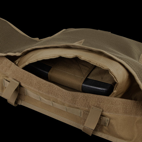 A close-up of the Condor Enforcer Releasable Plate Carrier in tan shows its open pocket with a black ballistic plate inside—an essential EDC gear choice for first responders.